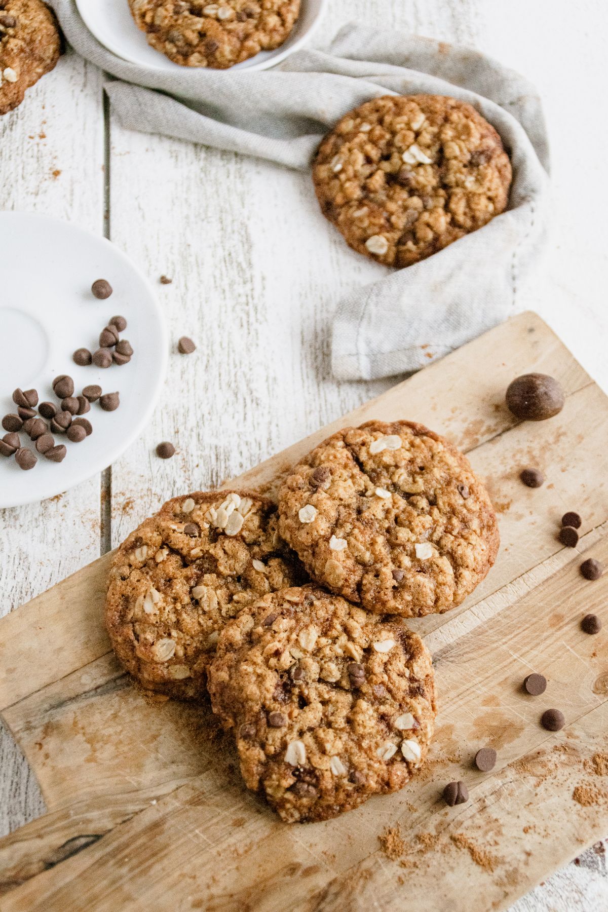 Stack of chewy oatmeal chocolate chip cookies with visible rolled oats and melted chocolate chips.